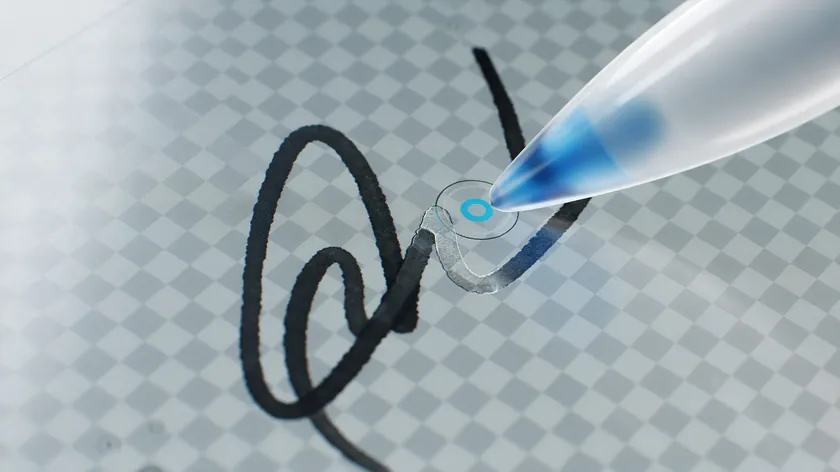 Extreme close-up of a signature stroke being touched up with an editing brush after using a tool to remove background from signature scans.