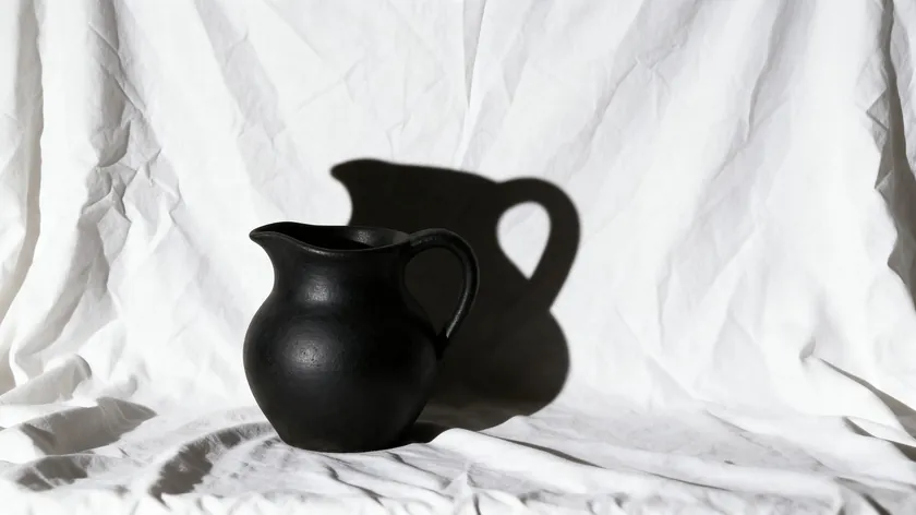 A product photo showing common white background mistakes, including a wrinkled backdrop and a harsh visible shadow behind the item.